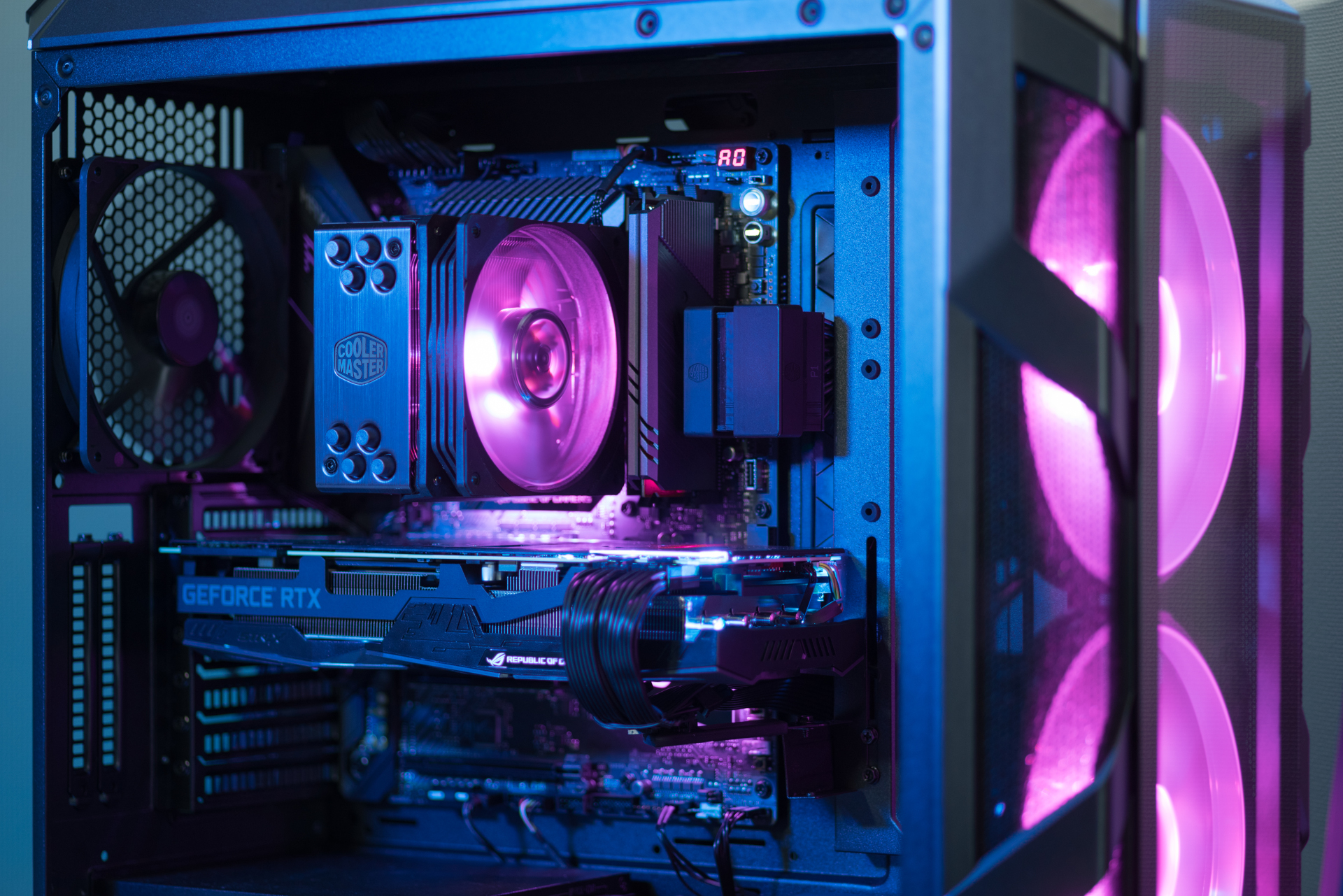 Close-up photo of the inside of a PC, all the components glowing brightly with purple light.