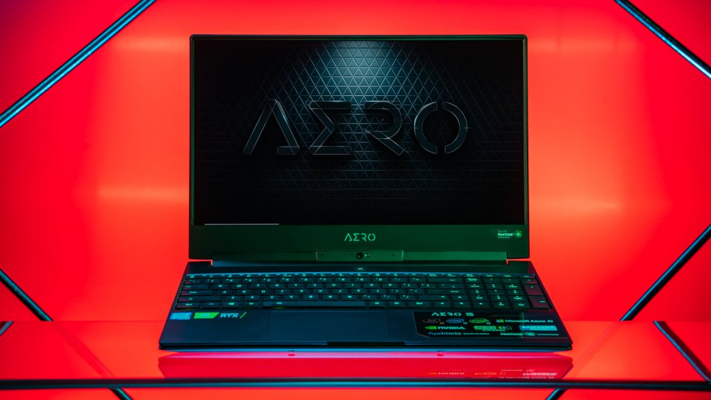 Close-up photo of a gaming laptop against a red background.
